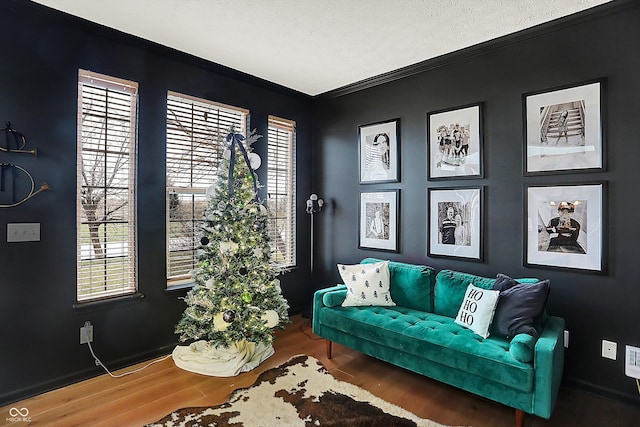 sitting room with crown molding, hardwood / wood-style floors, and a textured ceiling