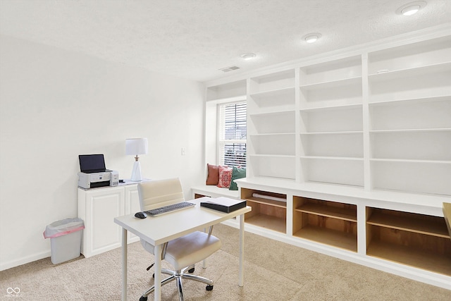 home office featuring light carpet and a textured ceiling