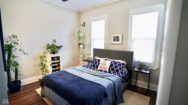 bedroom featuring baseboards and wood finished floors