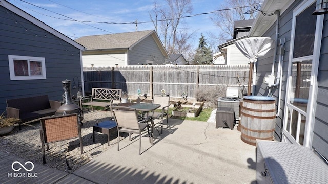 view of patio with outdoor dining space and a fenced backyard