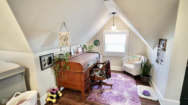 office space featuring lofted ceiling, wood finished floors, and baseboards