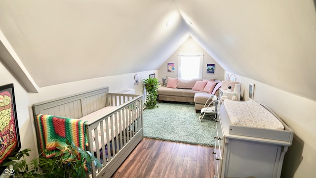 bedroom featuring lofted ceiling and wood finished floors