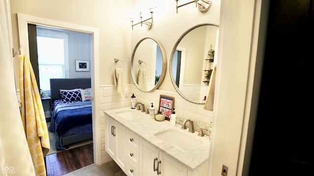 full bathroom featuring a sink, ensuite bath, and double vanity