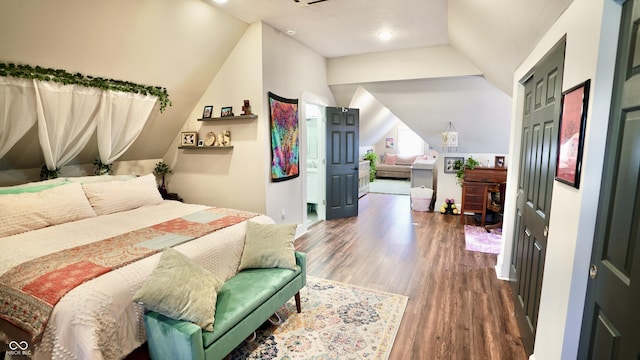 bedroom with vaulted ceiling and wood finished floors