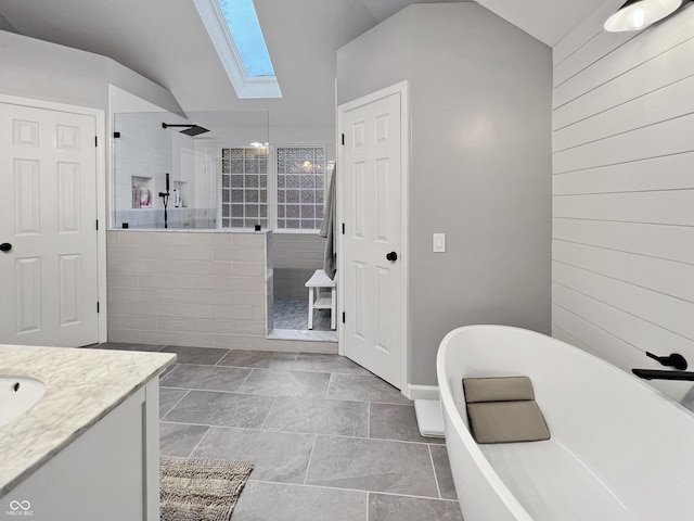 bathroom with plus walk in shower, vanity, wood walls, and lofted ceiling with skylight