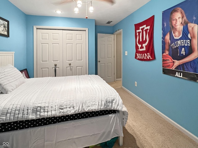 carpeted bedroom featuring ceiling fan and a closet