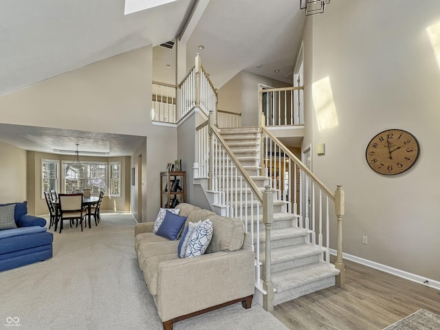 living room with hardwood / wood-style flooring and high vaulted ceiling