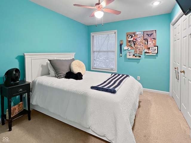 bedroom with light carpet, a closet, and ceiling fan