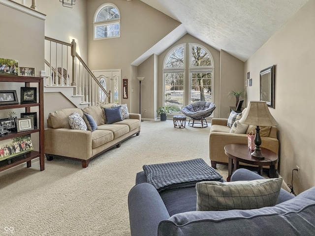 living room with carpet, high vaulted ceiling, and a textured ceiling