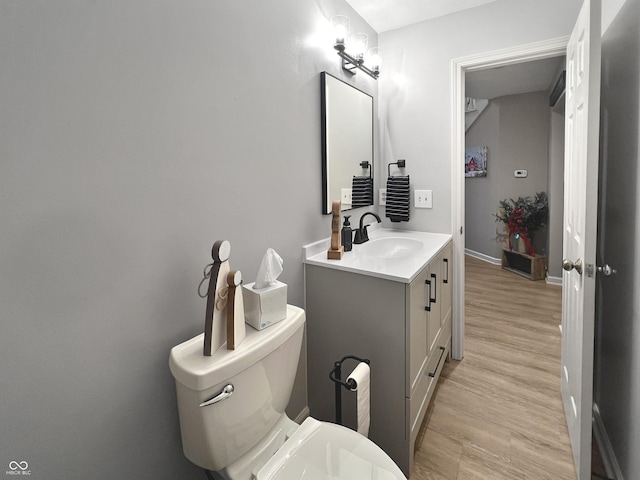 bathroom featuring hardwood / wood-style floors, toilet, and vanity