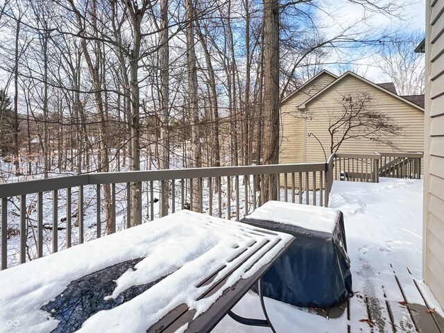 snow covered deck featuring a grill