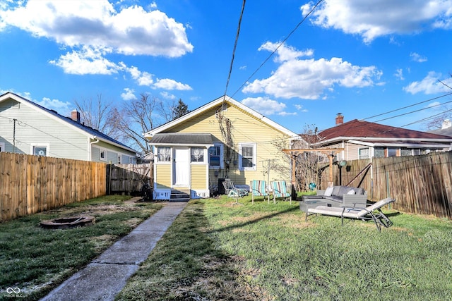 rear view of property with a yard