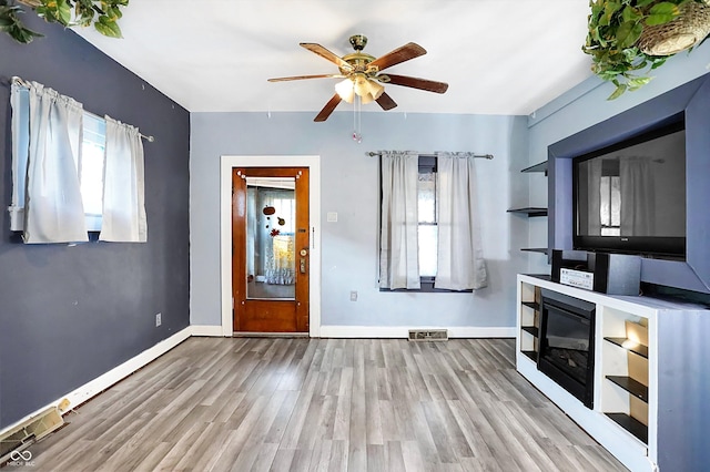 unfurnished living room featuring light hardwood / wood-style floors and ceiling fan