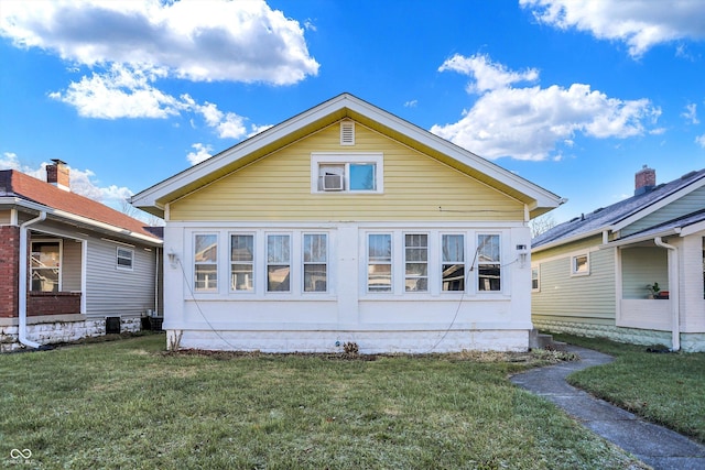 back of property featuring a lawn