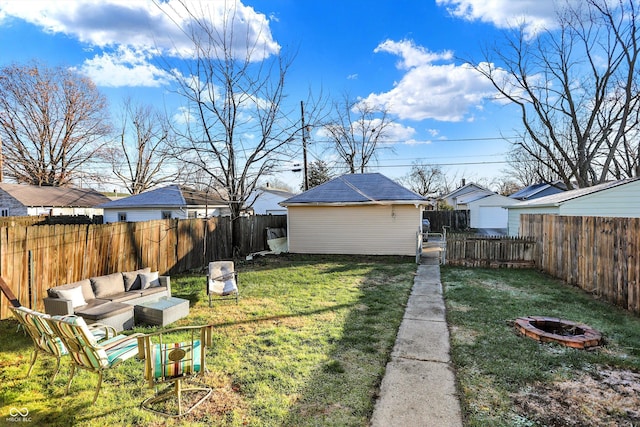 view of yard with an outbuilding and an outdoor living space with a fire pit