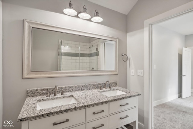 bathroom featuring vanity, an enclosed shower, and vaulted ceiling