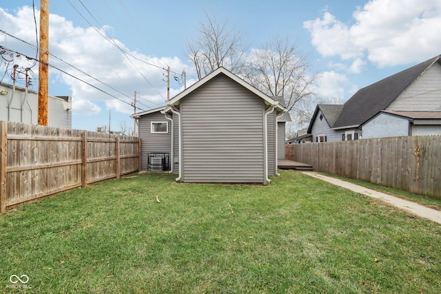 back of house with a wooden deck and a lawn