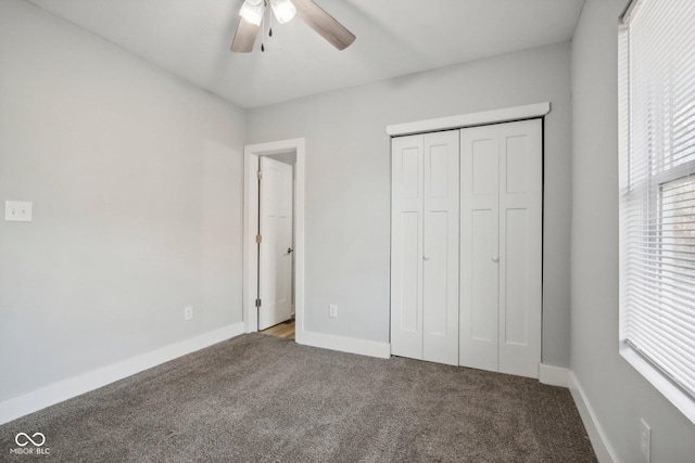 unfurnished bedroom featuring carpet, ceiling fan, and a closet