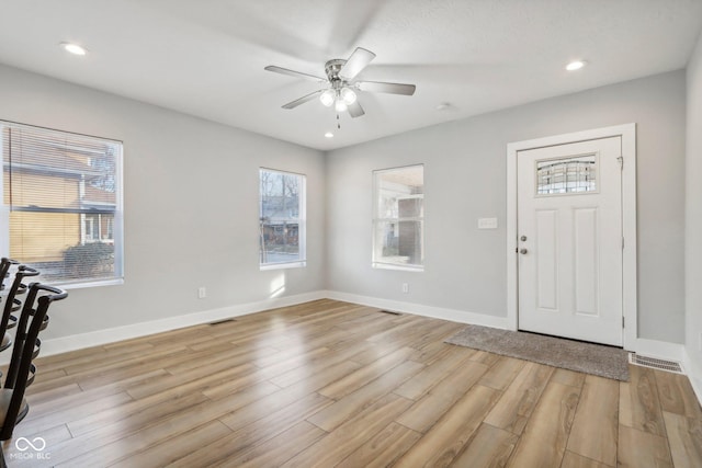 foyer with ceiling fan and light hardwood / wood-style flooring