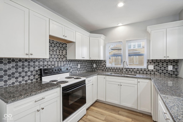 kitchen with white cabinets, light wood-type flooring, electric range, and sink