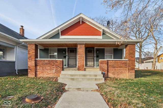 view of front of property with covered porch and a front lawn