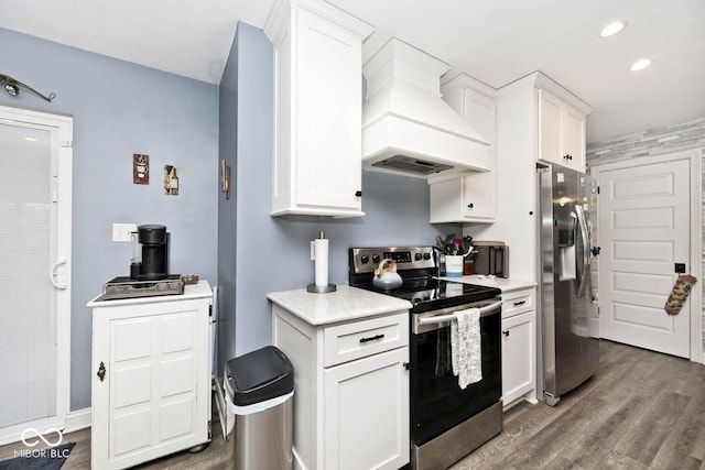 kitchen featuring appliances with stainless steel finishes, white cabinetry, custom range hood, and dark wood-type flooring