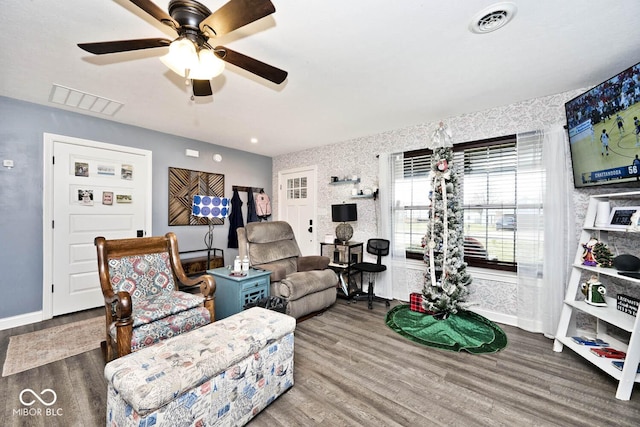 living room featuring hardwood / wood-style flooring and ceiling fan