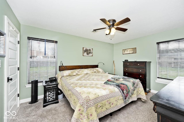 bedroom featuring ceiling fan and light carpet