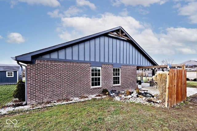 view of side of home with a lawn