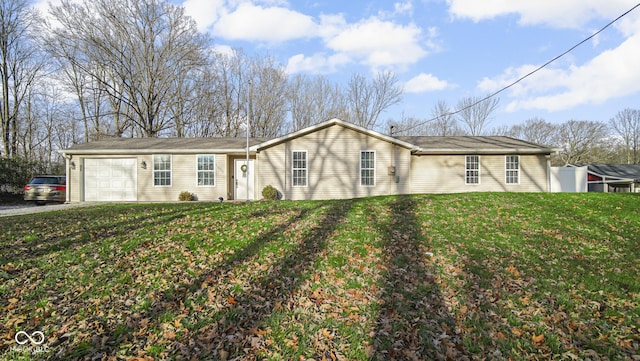 ranch-style home featuring a front lawn and a garage