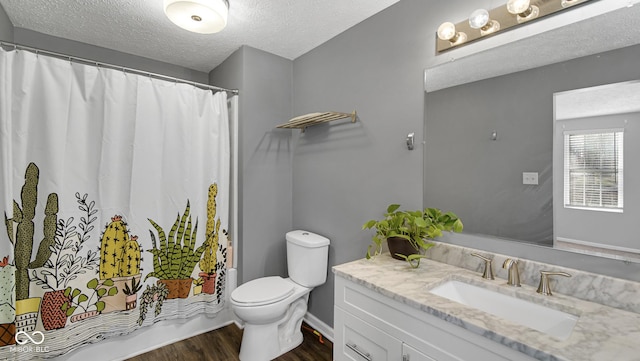 bathroom featuring hardwood / wood-style floors, vanity, a textured ceiling, and toilet