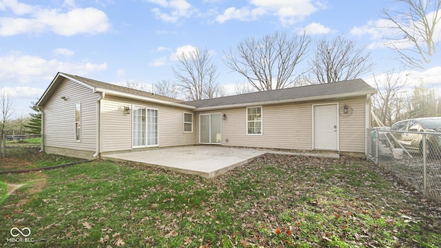 rear view of property with a yard and a patio area