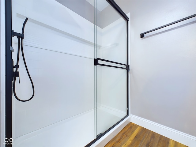 bathroom with a shower and wood-type flooring