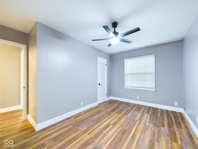 spare room featuring ceiling fan and dark hardwood / wood-style flooring