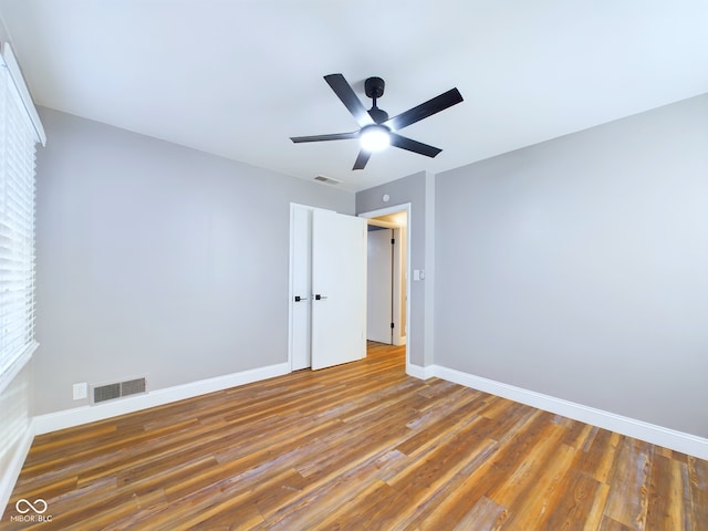 unfurnished bedroom with ceiling fan and hardwood / wood-style floors