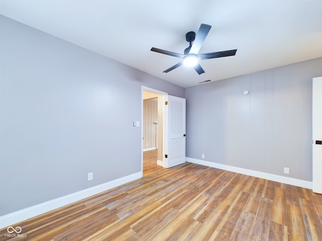 empty room featuring ceiling fan and light wood-type flooring