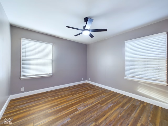 empty room featuring ceiling fan and dark hardwood / wood-style flooring