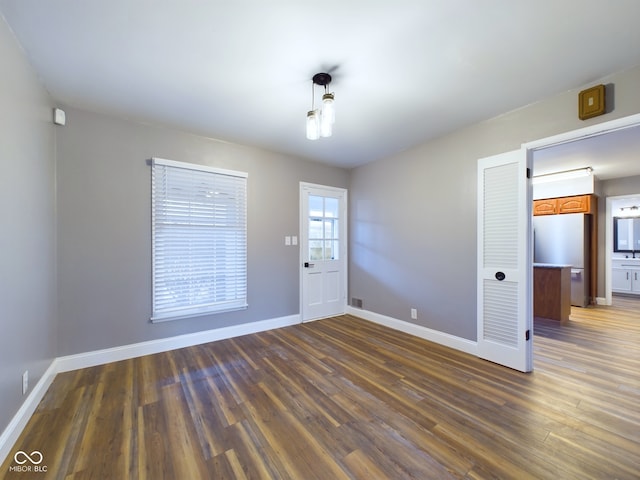 empty room featuring dark hardwood / wood-style flooring