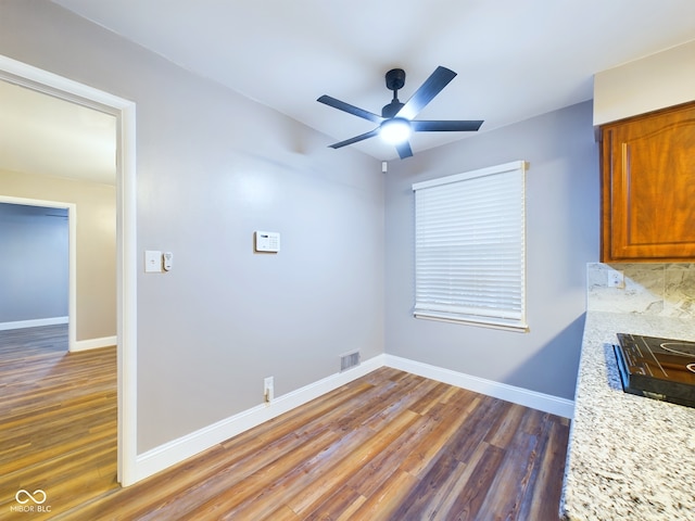 interior space featuring dark hardwood / wood-style floors and ceiling fan