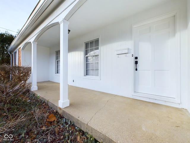 view of exterior entry featuring a porch