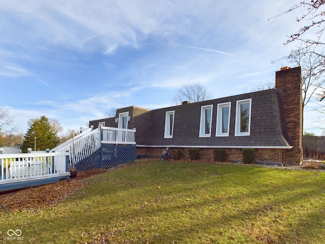 view of home's exterior featuring a yard and a deck