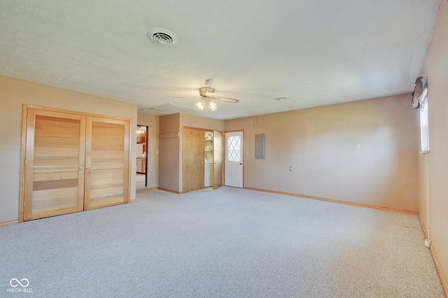 unfurnished bedroom featuring ceiling fan, light colored carpet, and electric panel