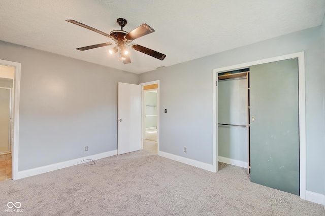 unfurnished bedroom with ceiling fan, light carpet, and a closet