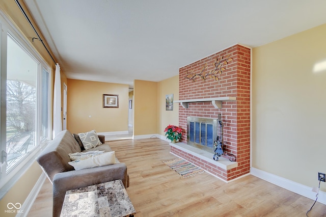 living room with a fireplace and hardwood / wood-style floors