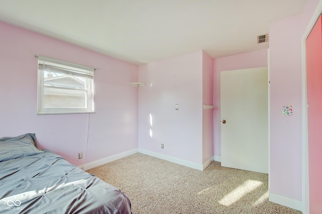 bedroom featuring light colored carpet