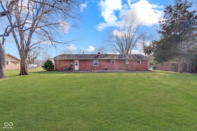 back of house with a lawn