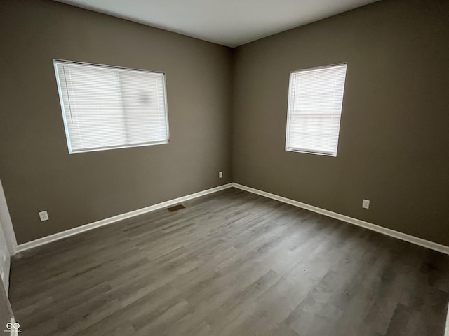 unfurnished room with hardwood / wood-style flooring