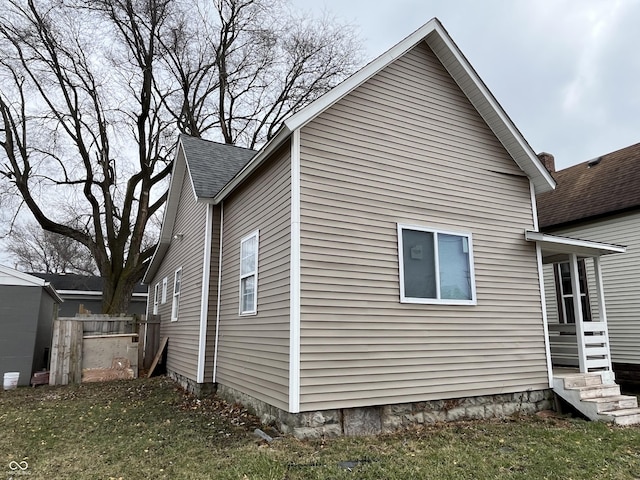 view of property exterior with a yard