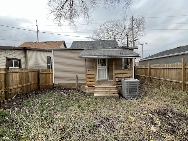 back of house with central AC unit and a deck