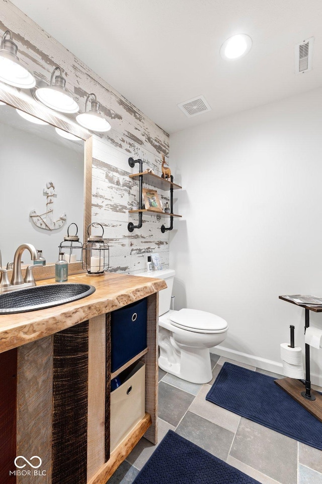 bathroom featuring tile patterned floors, vanity, and toilet